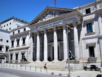 Façade of Spain’s Congress in Madrid, showing its columns and an entrance lion.