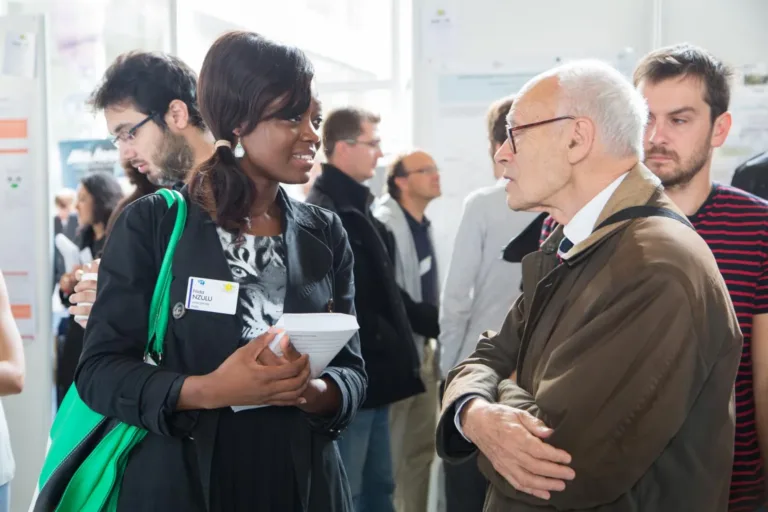 Henri Kagan talks with attendees at an organic chemistry gathering