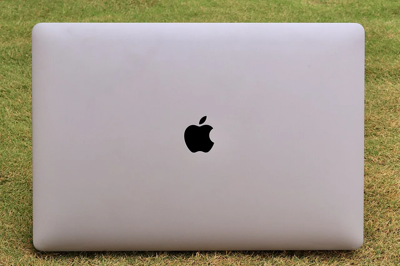 File photo from March 10, 2020: a closed MacBook Pro on the grass, seen from above, with the Apple logo on the lid.