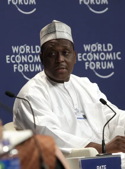 File photo from September 12, 2012: Muhammad Ali Pate, dressed in white and seated before microphones at a World Economic Forum meeting in Tianjin, China.