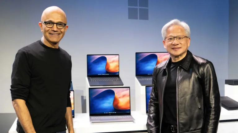 Satya Nadella and Jensen Huang alongside laptops during the RTX Spark announcement