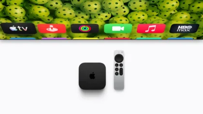 The fourth-generation Apple TV 4K and Siri Remote beneath a television.