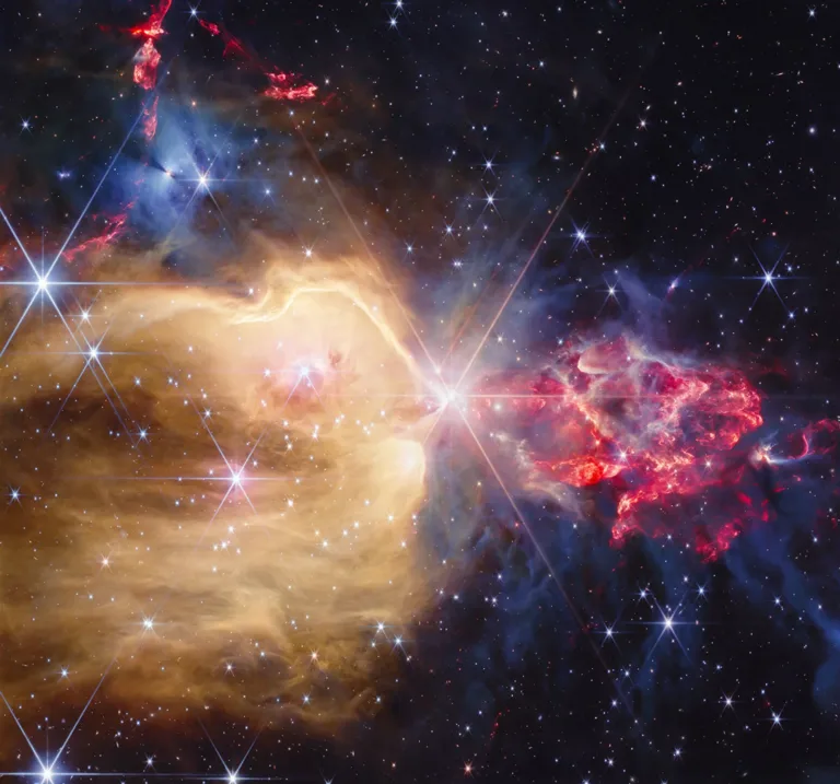 Infrared observation of NGC 7129 by Webb, showing a golden region of gas and red jets around young stars