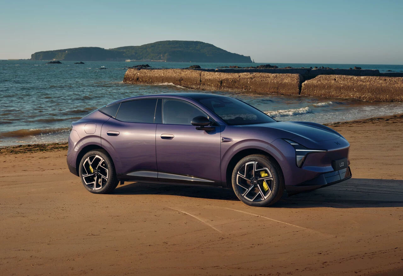 Purple XPeng L03 parked by the sea in an official press photograph